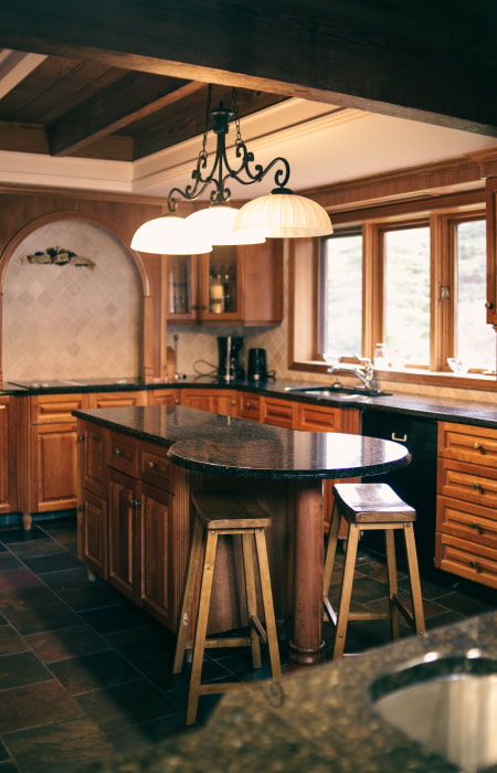 Circular kitchen island design with wooden base cabinets & marble countertop - Beautiful Homes