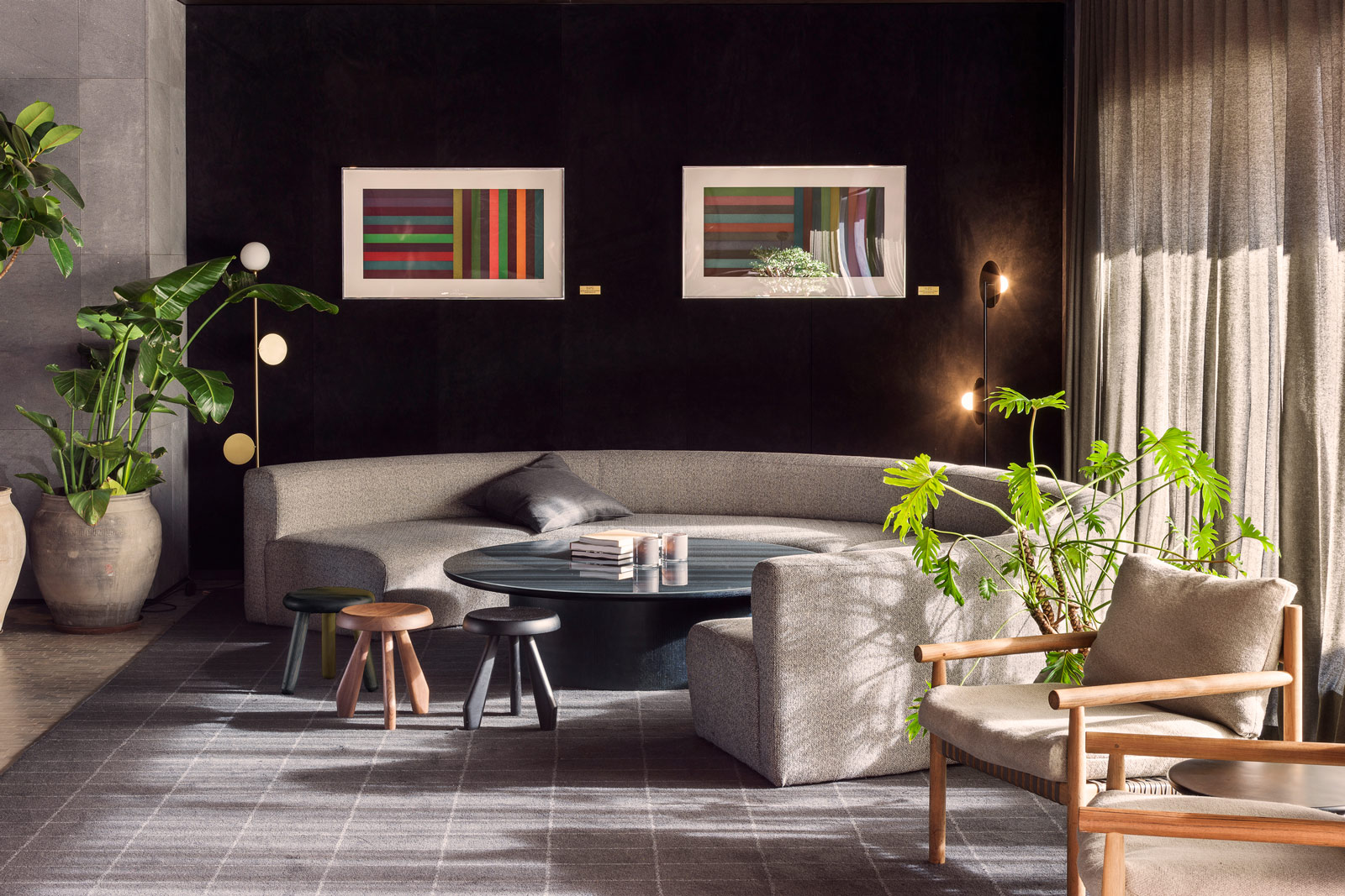 Black Wall For Your Designer Living Room With Cream Round Sofa - Beautiful Homes