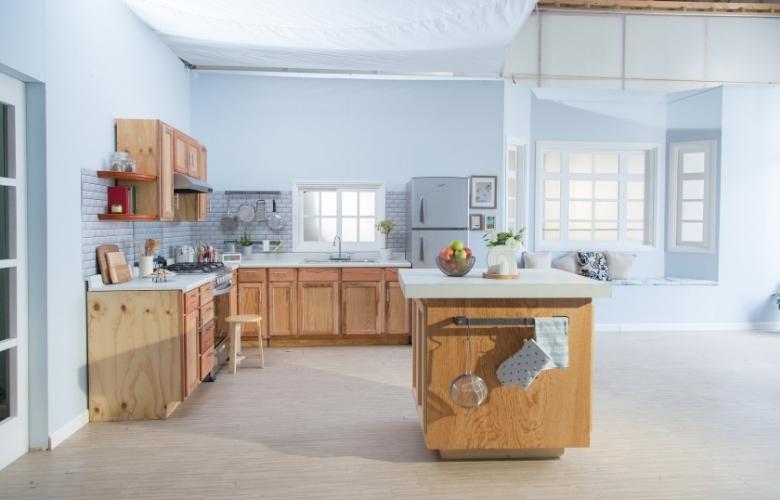 Blue shade peninsula kitchen interior design with wooden interiors - Beautiful Homes