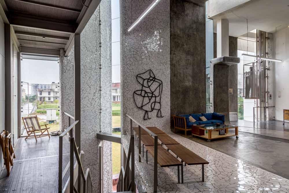 A home with concrete interiors, wooden furniture and an artwork hung on the wall - Beautiful Homes