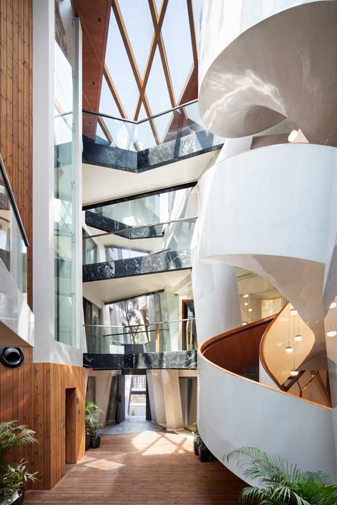 A white spiral staircase in a house with lots of natural light coming into it  - Beautiful Homes