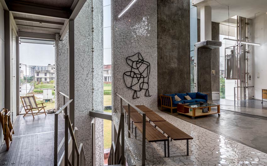 A home with concrete interiors, wooden furniture and an artwork hung on the wall