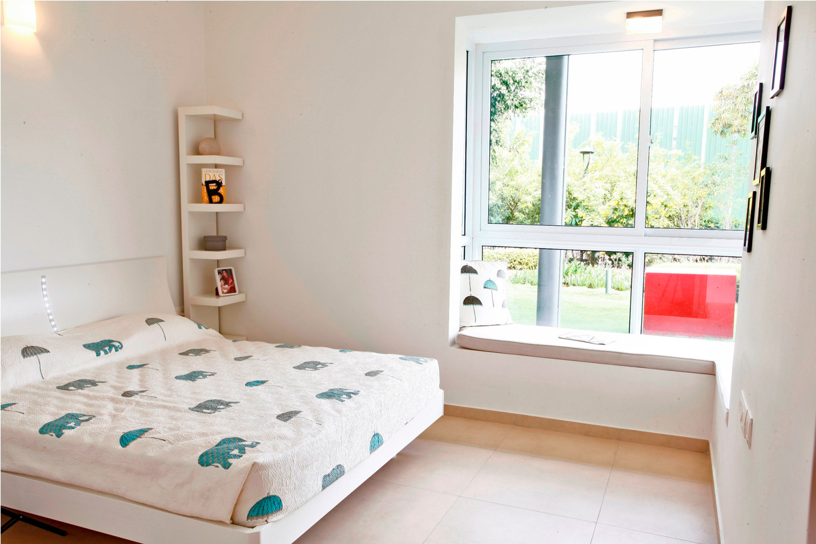 A full-white bed covered with a printed bedspread - Beautiful Homes