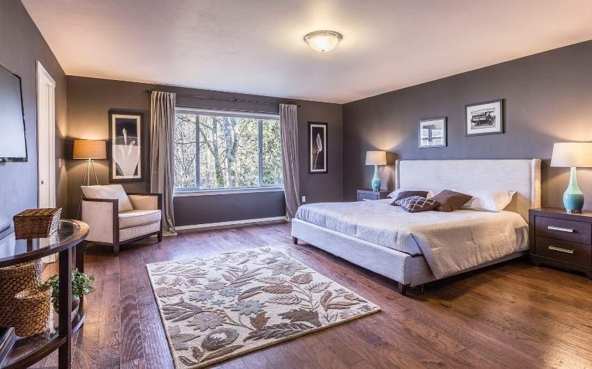 Bedroom with a small center ceiling light, floor & table lamps in the corner - Beautiful Homes