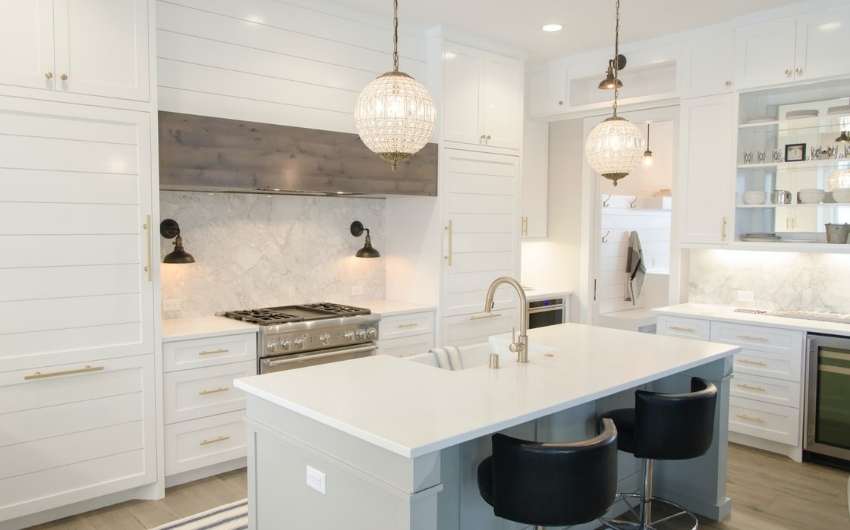 An all white modular kitchen with tall units for storage - Beautiful Homes