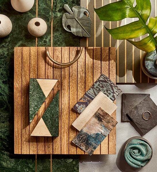 A moodboard with a piece of wood, some tiles and a leaf