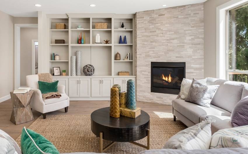 Stone fire place designs in a furnished living room - Beautiful Homes