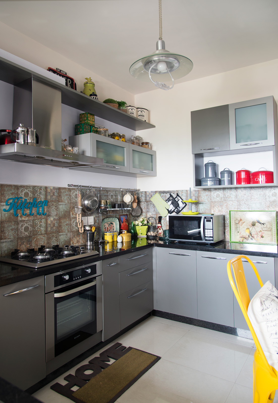 Monochrome kitchen in grey shades with hints of yellow, red and blue décor