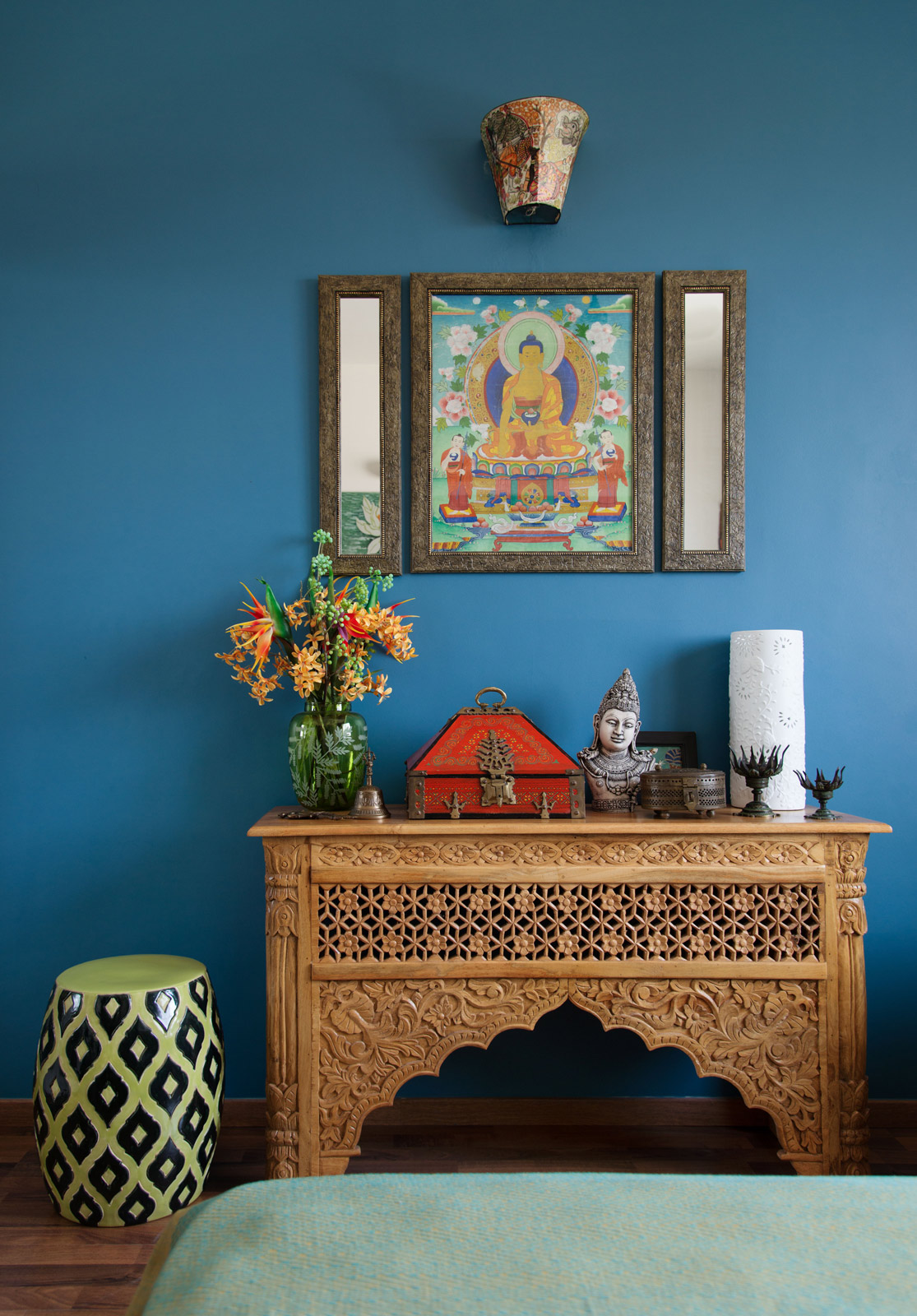 Ornamental figures on a carved wooden console in the guest room in Avilasha Barooah's Bangalore house