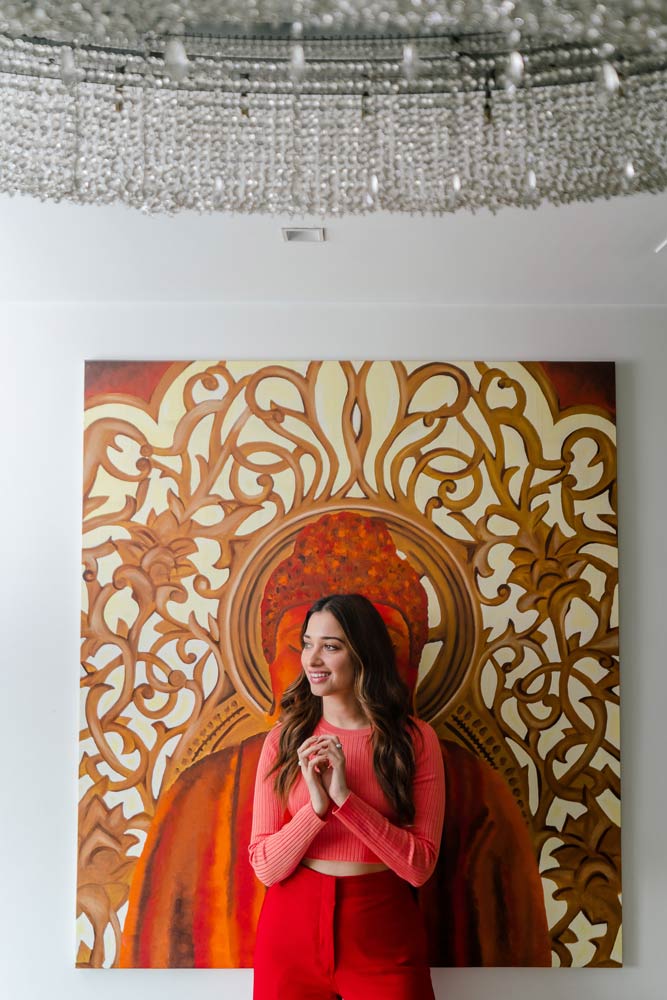 Tamannaah in front of a large wall artwork that lends a spot of colour - Beautiful Homes