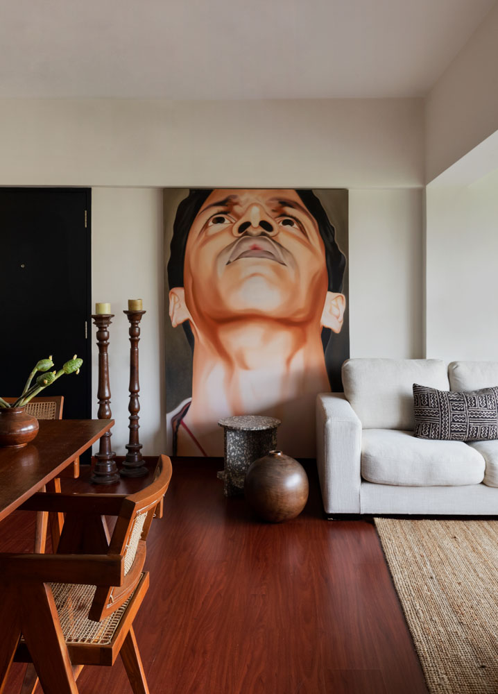 Oversized portrait by Riyas Komu is a focal point in the living room - Beautiful Homes