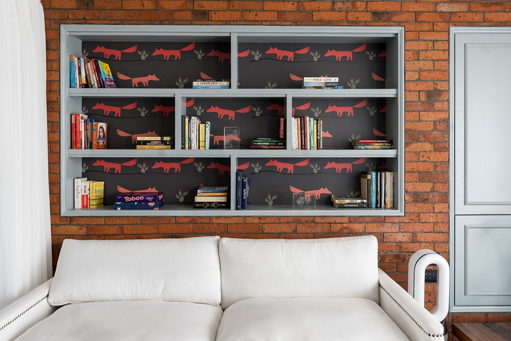 Bookshelf with unique wallpaper background on a bricked wall for house interior design - Beautiful Homes