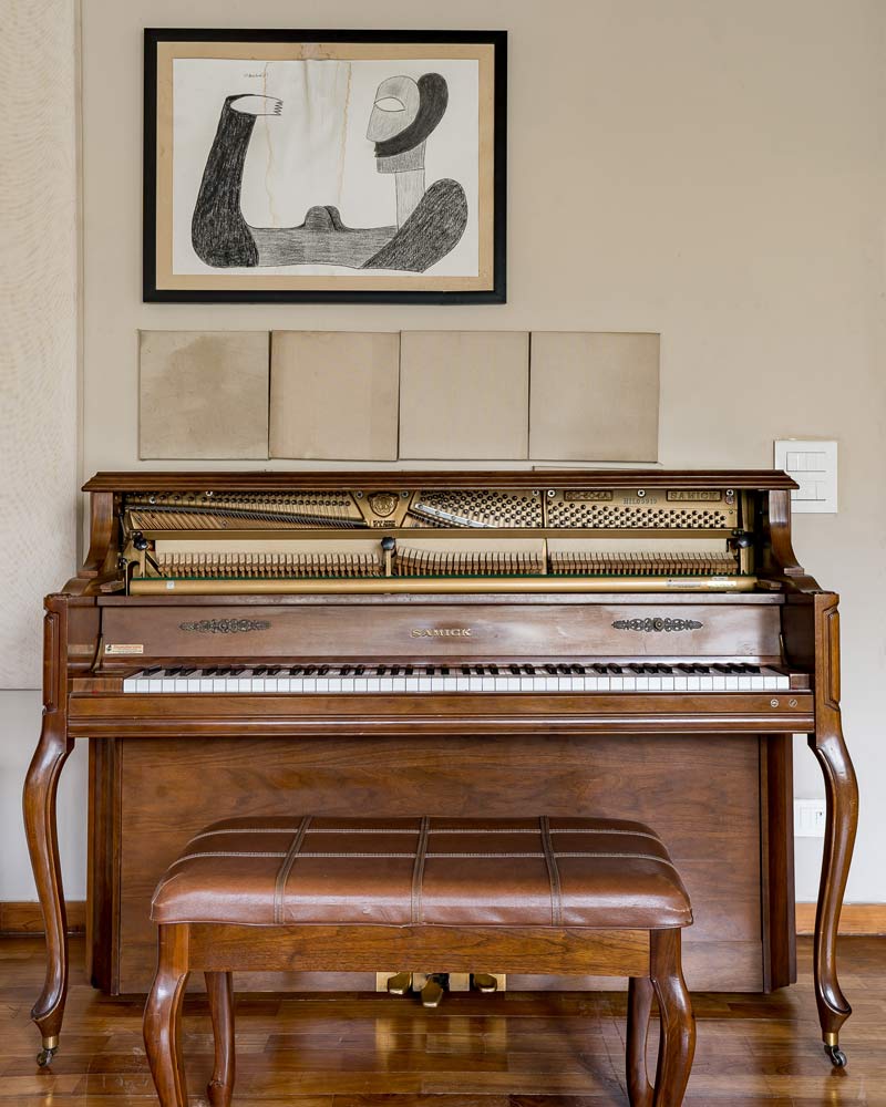 A traditional piano set accessorized by home décor elements adds a chic side to the home design - Beautiful Homes