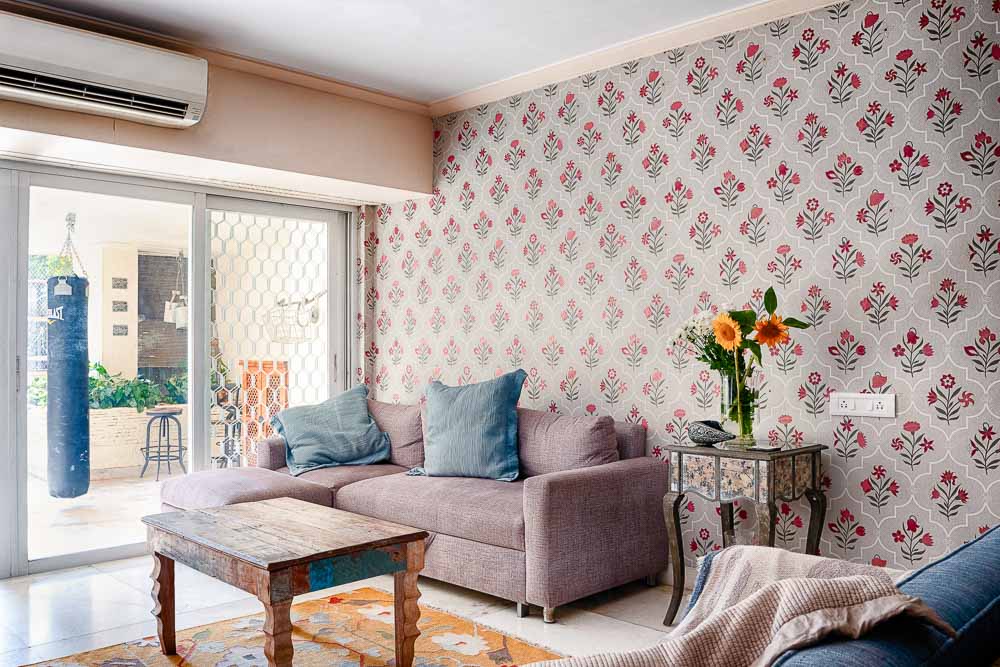 Wallpaper by Nilaya for Asian Paints on a living room wall with colourful and distressed furniture