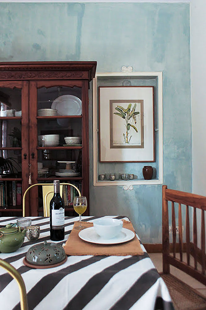 A dining table with a wooden chair, a glass of wine and white china cutlery - Beautiful Homes