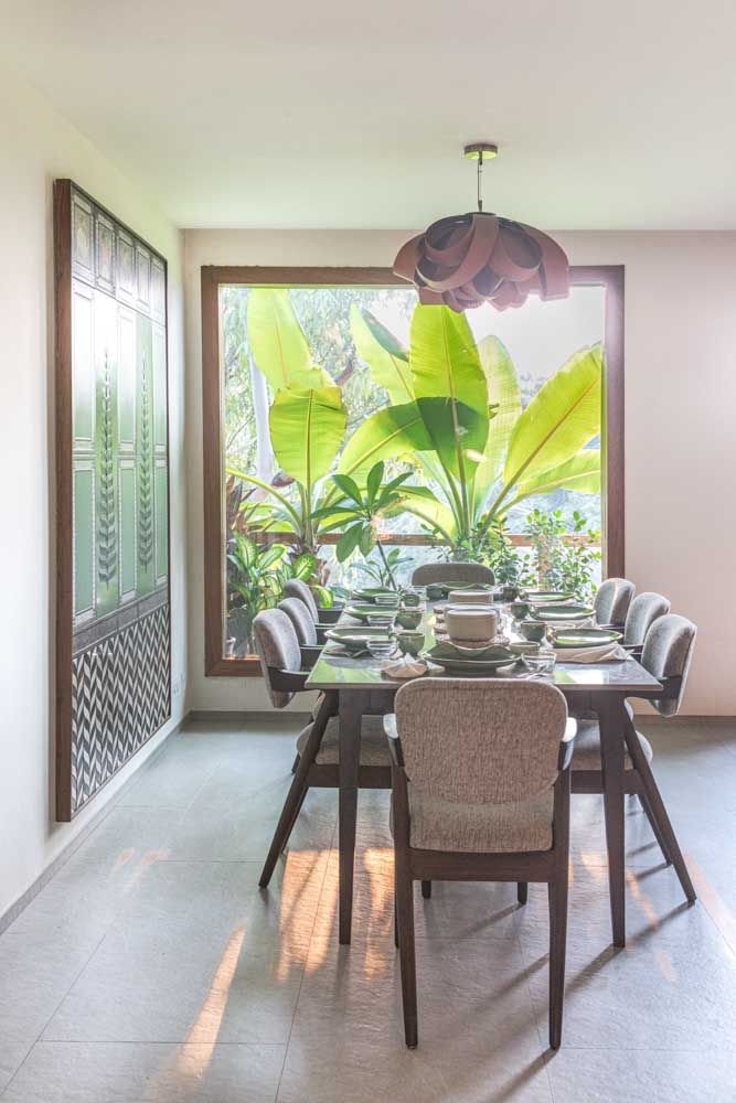 An eight seater dining table overlooking a large window