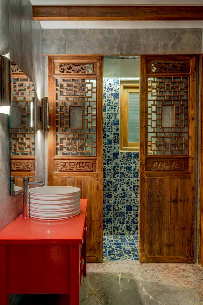 The washroom with a shower in intricate patterns and bright red colour