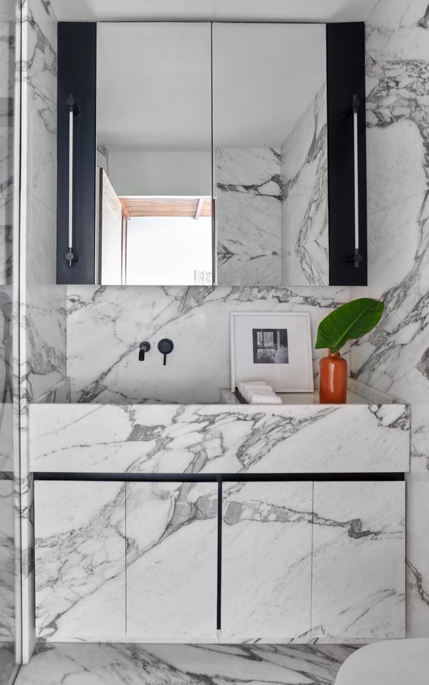 Italian marble features custom-made vanity & basin for the bathroom interior design - Beautiful Homes
