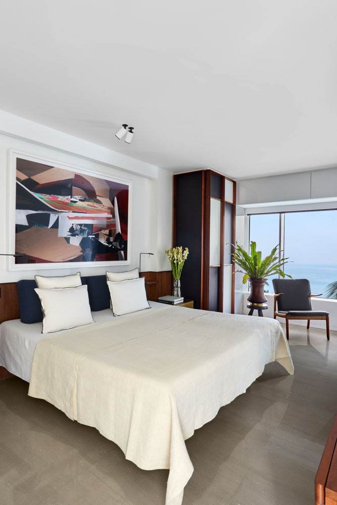 Master bedroom interior design with sea views that has custom made bedside tables - Beautiful Homes