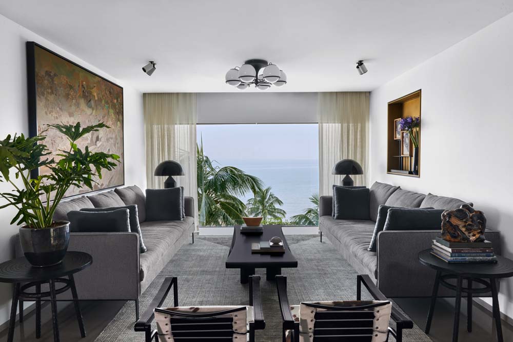 Symmetrical arrangement of sofas & chairs in the sea-facing living room - Beautiful Homes