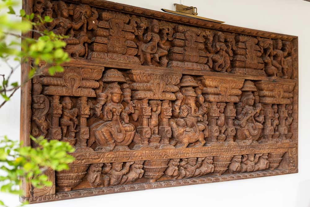 A rectangle shaped intricate wood carved wall panel