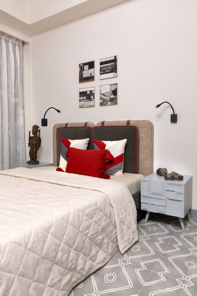 A minimalist bedroom design with red bedding & a chic side table for Firdaus's son - Beautiful Homes