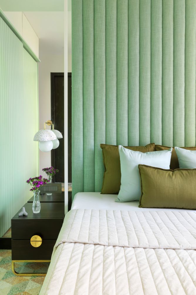 Classy mint green headboard in the bedroom with a minimalist side table & wall scone - Beautiful Homes