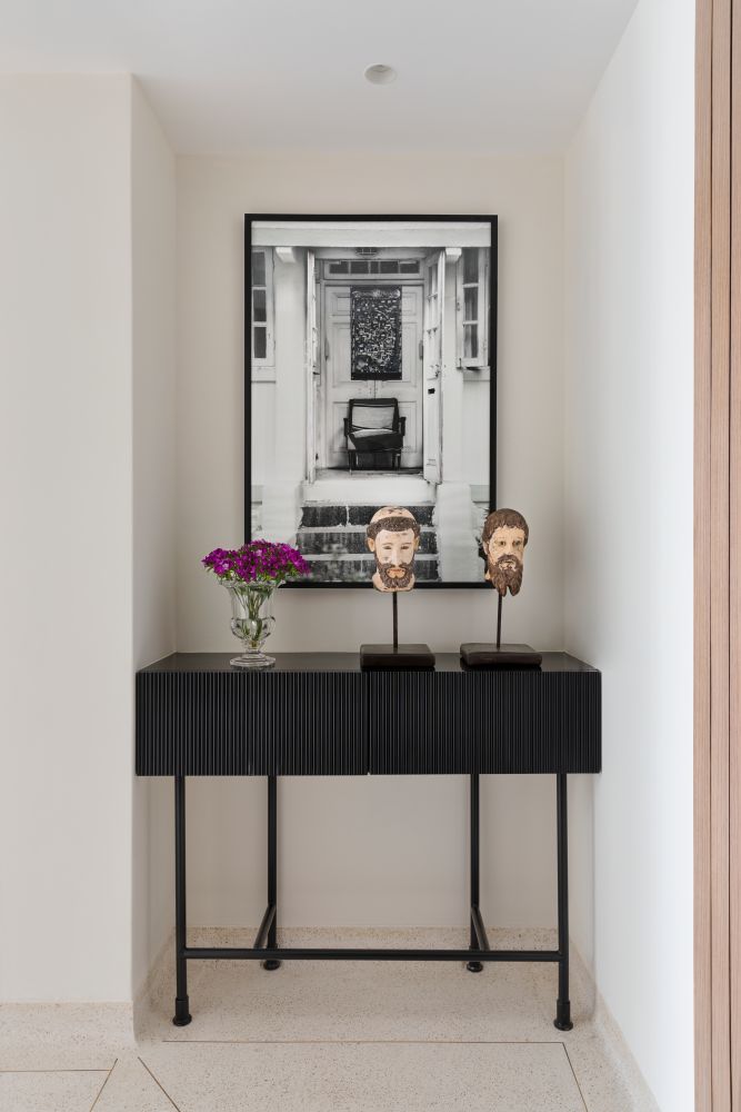 Entryway décor with sculptures & greyscale photo  - Beautiful Homes