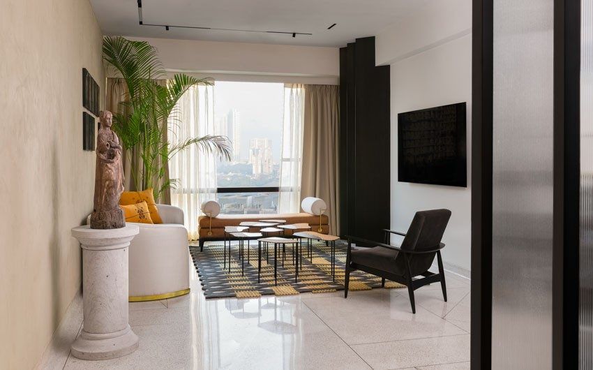White sofa with gold-rimmed base & unique rug pattern in the living room - Beautiful Homes