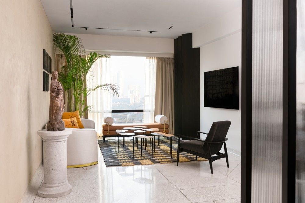 White sofa with gold-rimmed base & unique rug pattern in the living room - Beautiful Homes