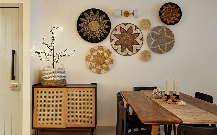 Dining room décor with wall plates & wooden dining table - Beautiful Homes