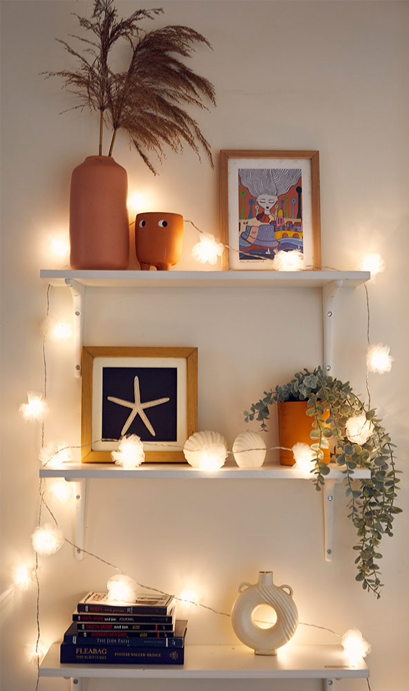 White shelf with string lights - Beautiful Homes