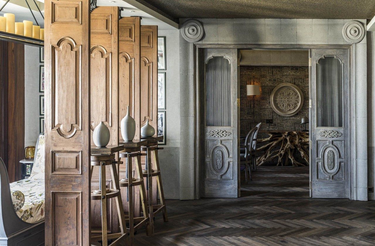 The section of the living room leading upto the family den features reclaimed doors - Beautiful Homes