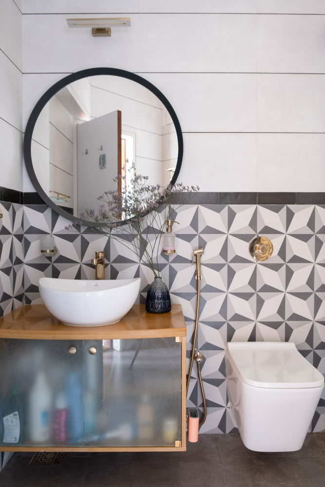 Master bathroom design has a black & white colour palette with golden colour accessories- Beautiful Homes