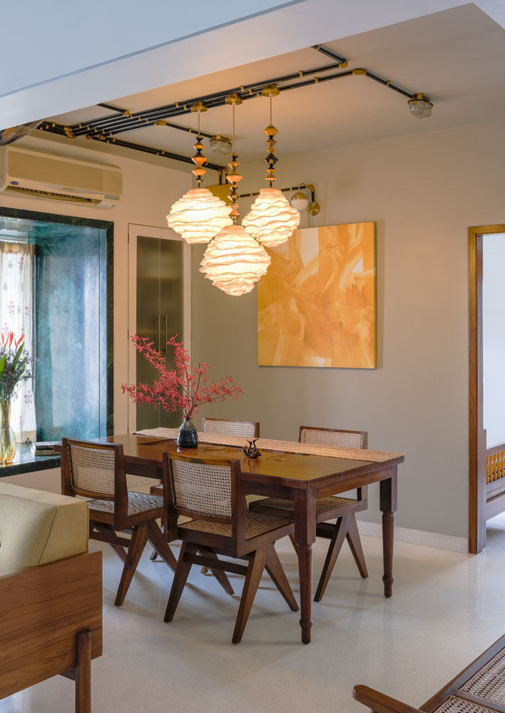 Dining room design is simple with designer pendant lights & coloured wall art - Beautiful Homes