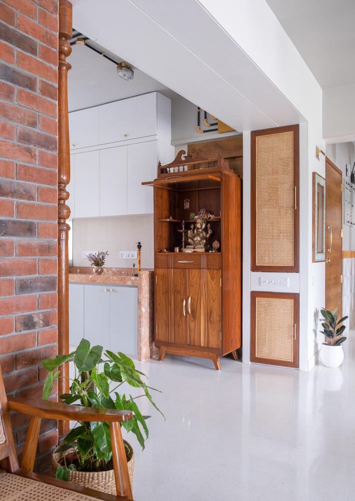 Pooja cabinet in the kitchen is custom-made from recycled teakwood - Beautiful Homes
