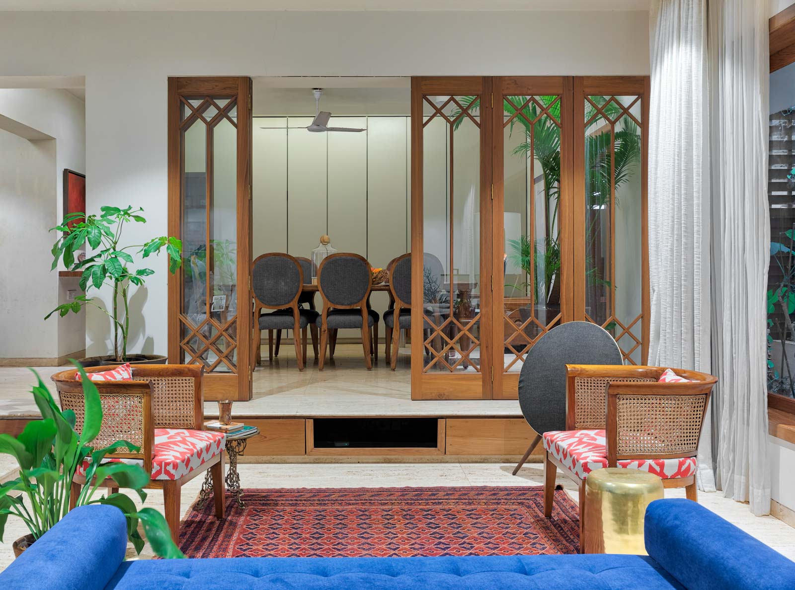 Living and dining room design with glass and wooden shutters - Beautiful Homes