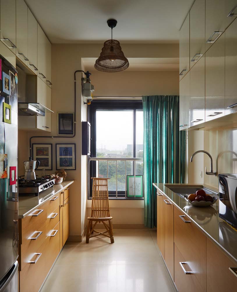 Parallel modular kitchen design with brass lamp & window treatment - Beautiful Homes