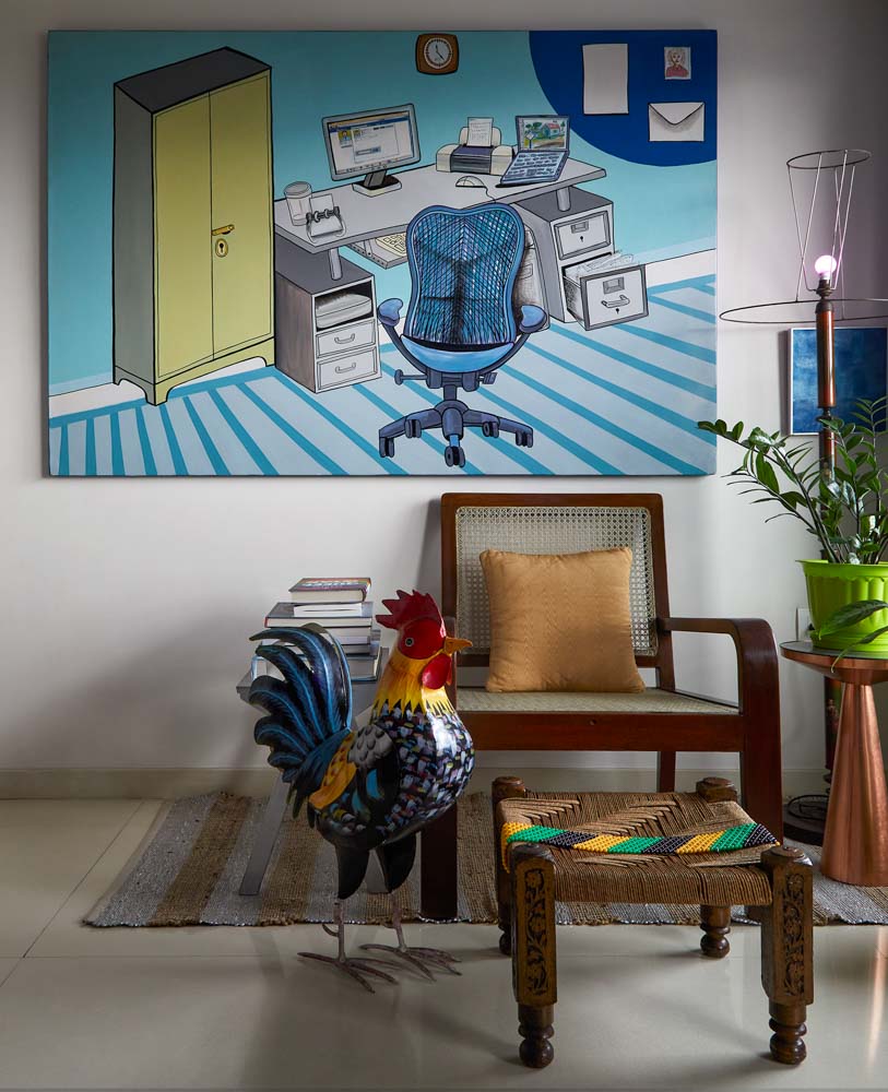Study room has wall painting, chair footstool & lamp as home décor items - Beautiful Homes