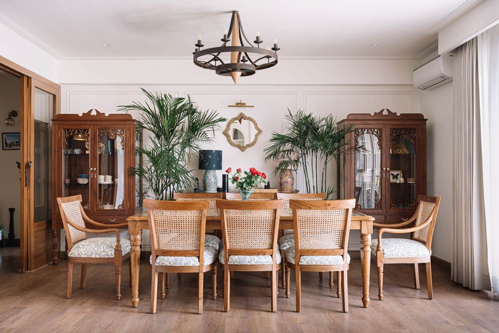 The wooden dining room has custom dining furniture with a traditional chandelier - Beautiful Homes