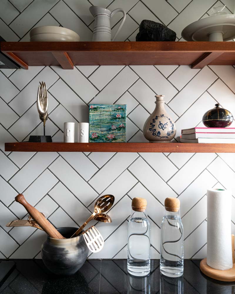 Herringbone pattern of the backsplash tiles for the floating shelves in the kitchen - Beautiful Homes