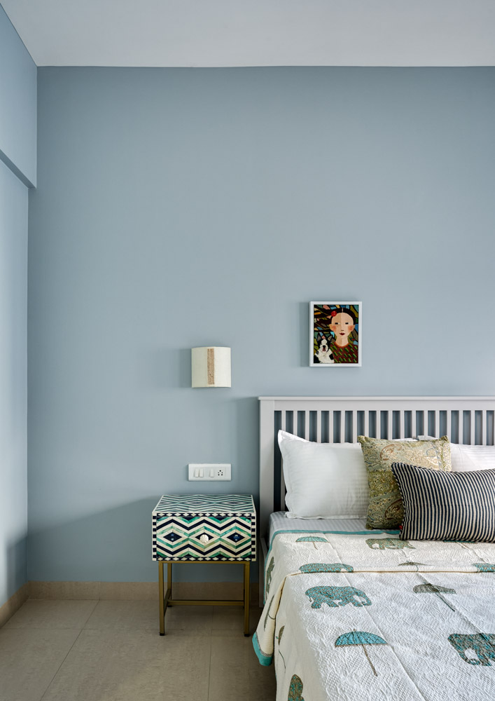 Guest room design with smoky blue colour palatte & bone inlay bedside table - Beautiful Homes