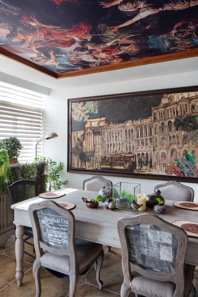 Dining room design has restored wooden dining furniture & printed wallpaper on the ceiling - Beautiful Homes