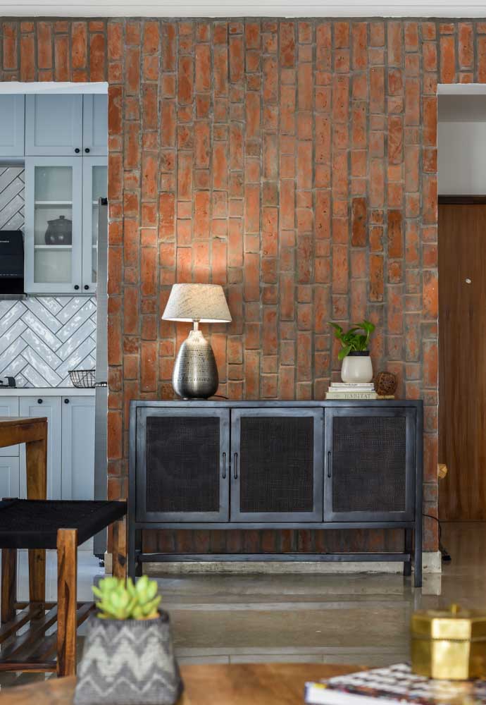 The dining room wall design is made of brick cladding that matches the home décor - Beautiful Homes