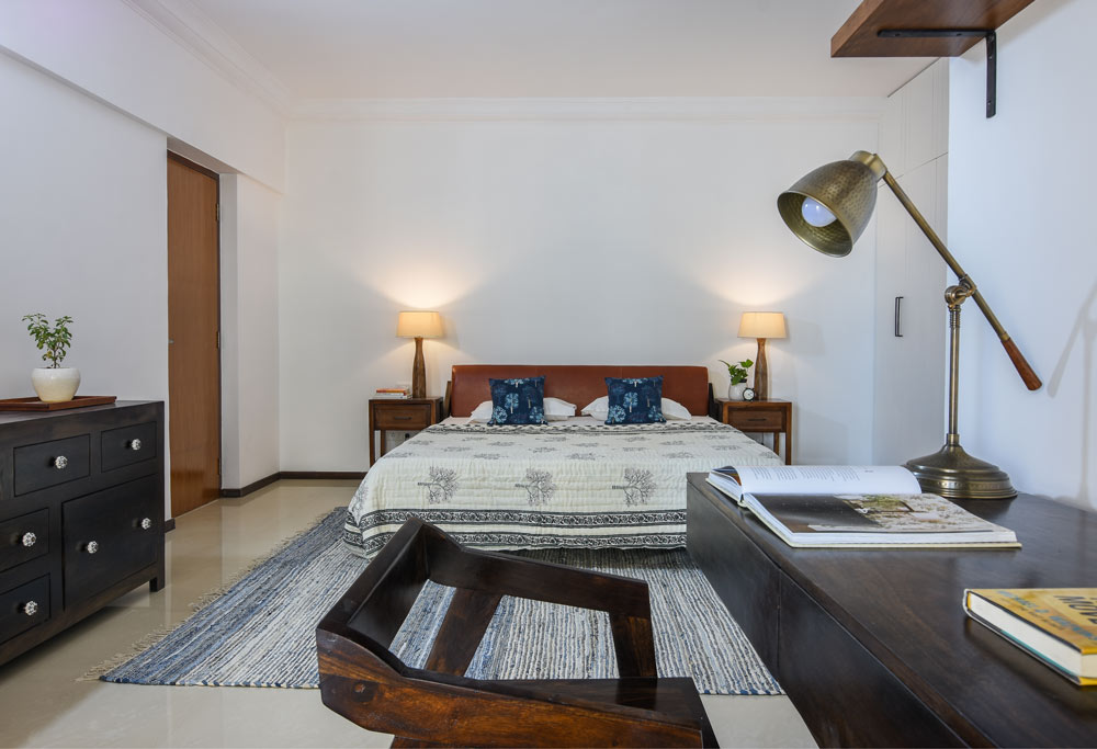 Earthy interior design of the master bedroom with table lamps & wooden furniture - Beautiful Homes