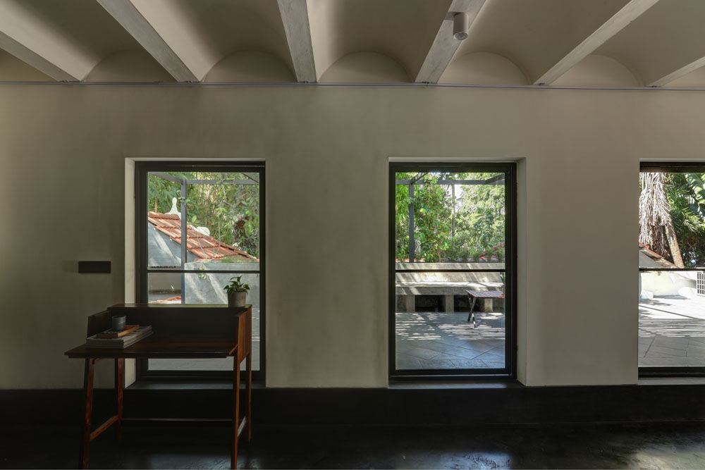 Three windows next to each other on a white wall overlooking a terrace - Beautiful Homes