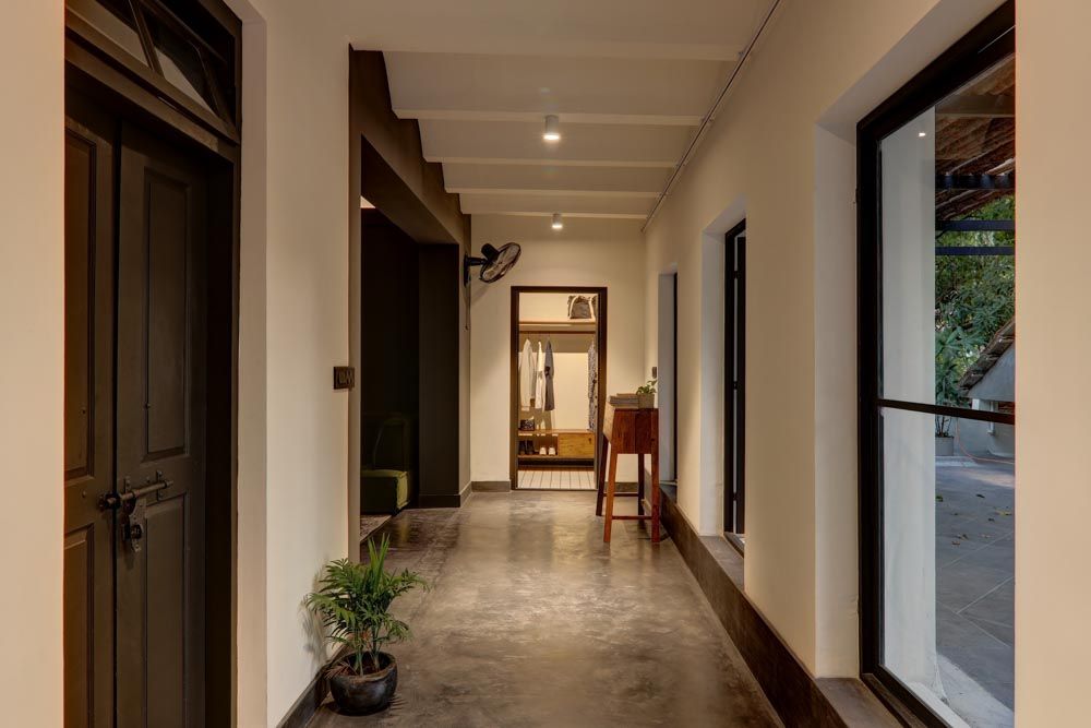 A dressing room at the end of a passage with windows on one side of the passage - Beautiful Homes