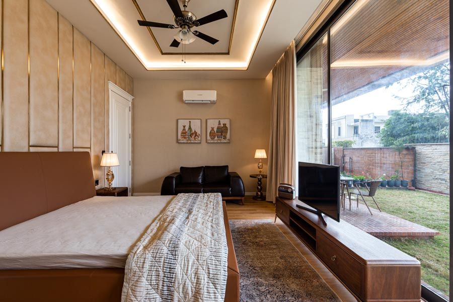 A bedroom with large windows overlooking a lawn - Beautiful Homes