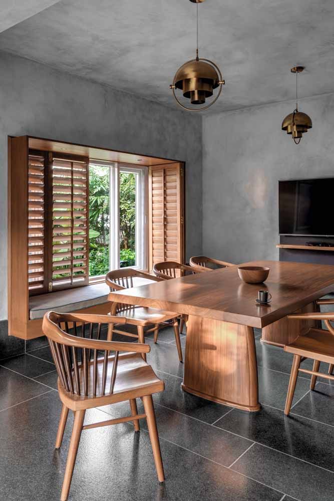 Dining room interior design features a beautiful wooden dining table with metallic lamps - Beautiful Homes