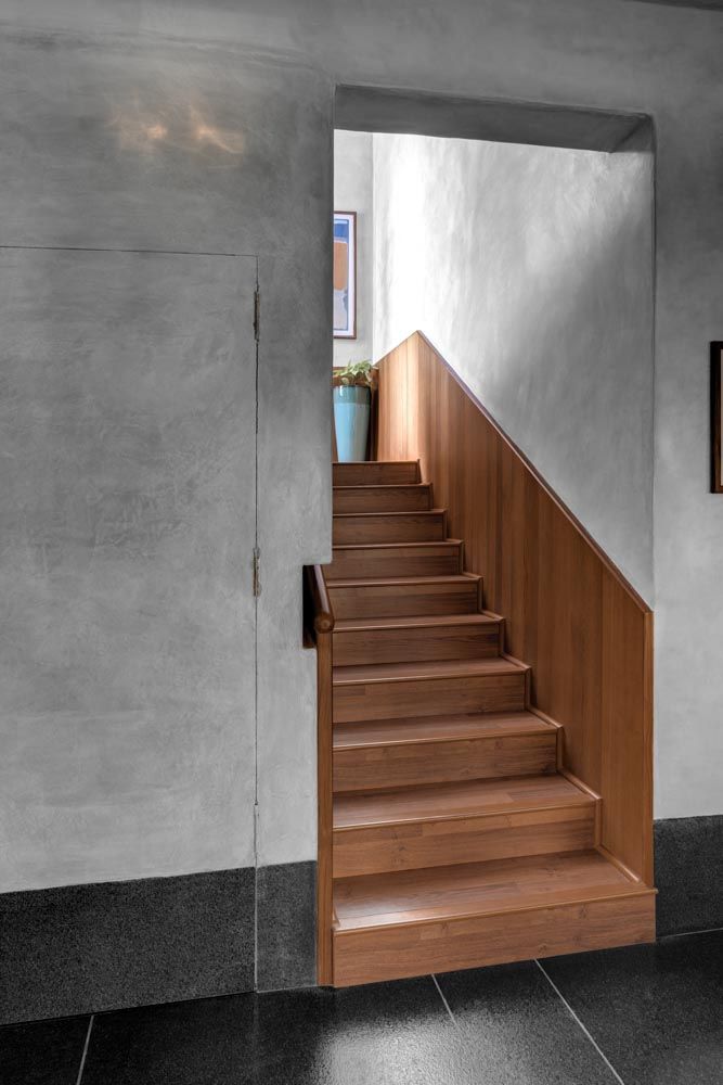 The staircase design is wooden & leads to the upper level of the house interiors - Beautiful Homes
